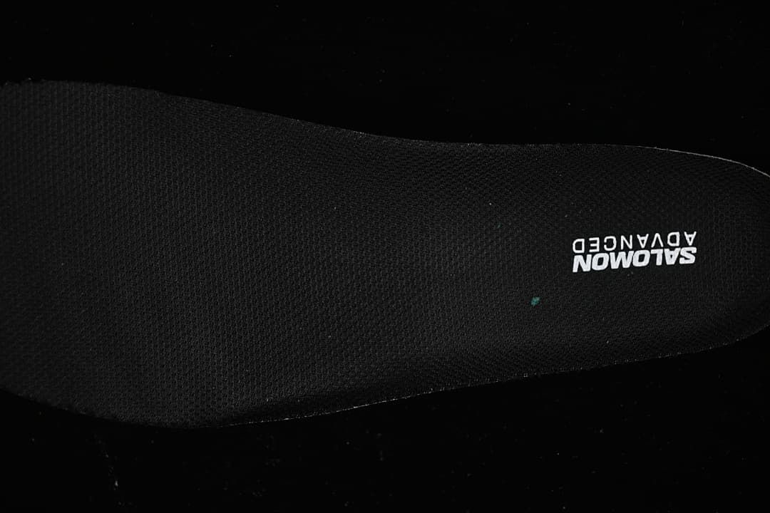 Close-up of the black insole with Salomon Advanced branding