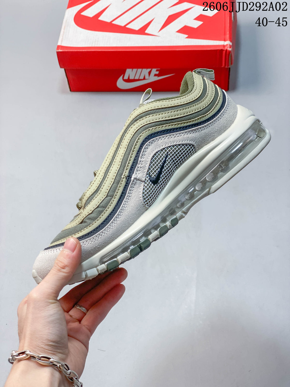 Side profile of a Nike Air Max 97 sneaker with layered wavy panels and a visible Air unit