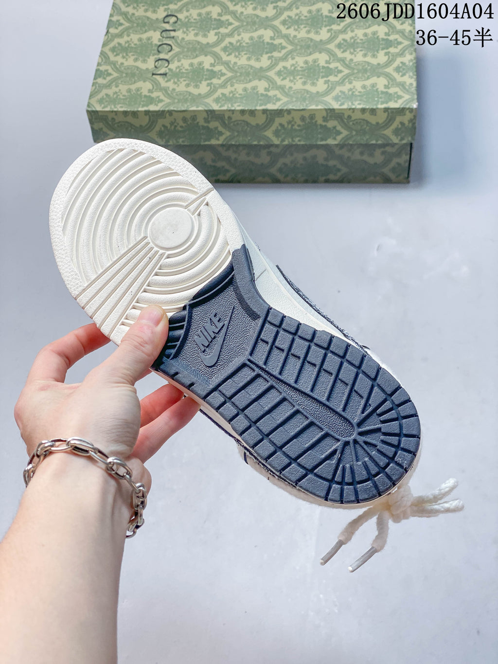 Underside of a Nike SB Dunk Low showing a cream and navy rubber outsole