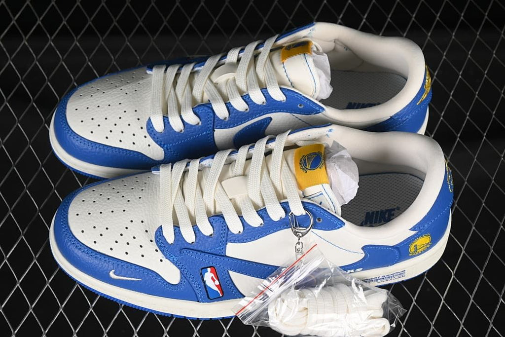 Pair of white and blue Warriors-themed low-top sneakers with white laces and a spare lace accessory