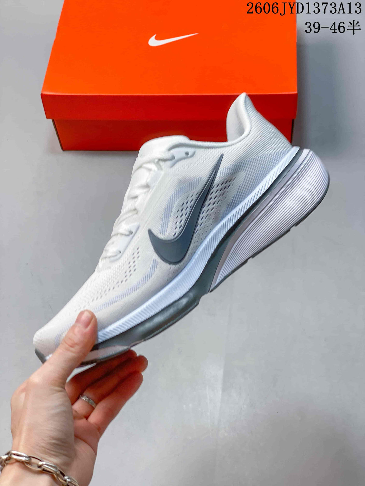 Side view of a white Nike Pegasus 42 running shoe with gray Swoosh