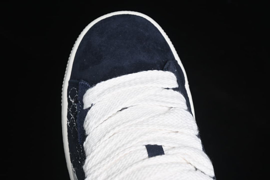Top-down close-up of the navy toe and white laces