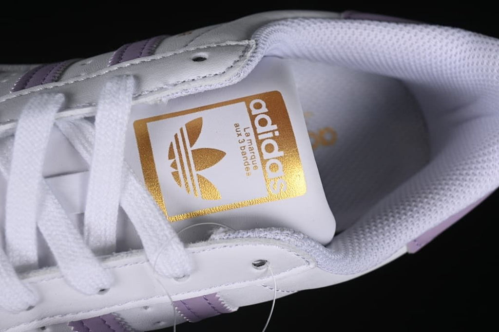 Top detail of the lace-up front and gold adidas tongue label
