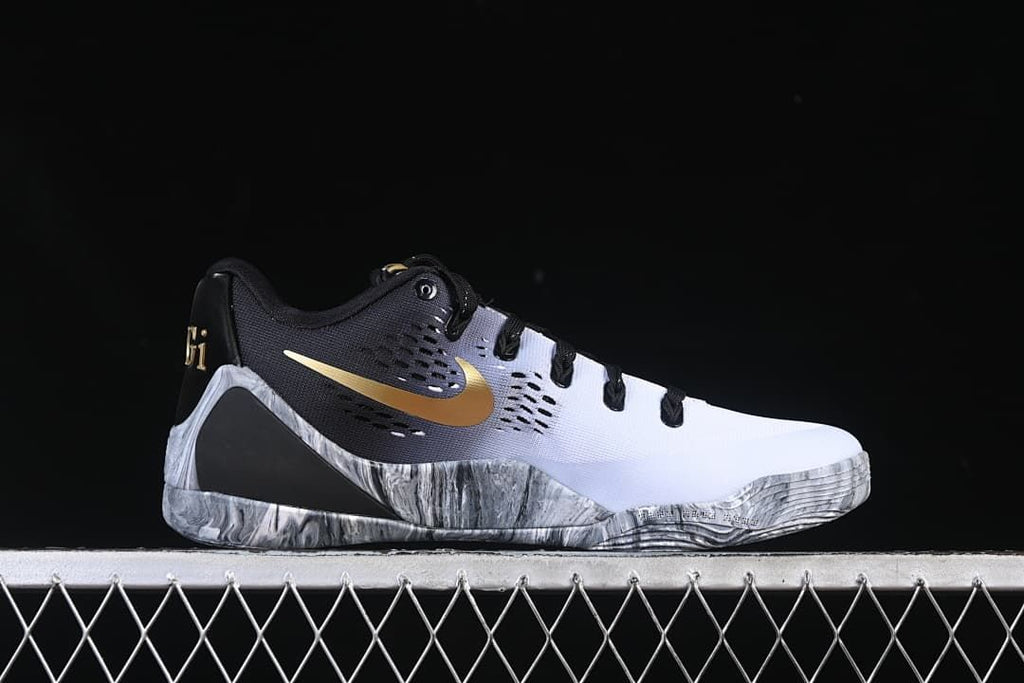 Side profile of the shoe with gold Swoosh and marbled gray sole