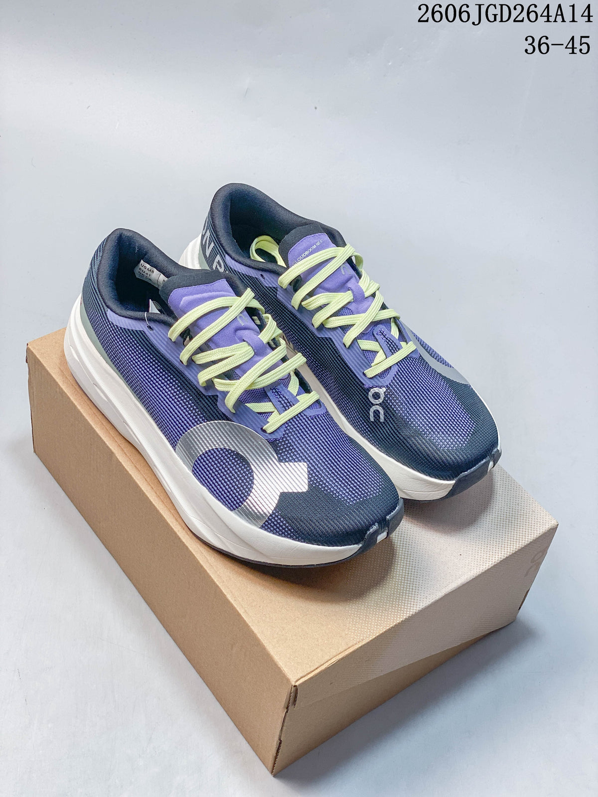 Pair of navy and purple On Cloudboom Volt running shoes with lime laces, shown on a box.