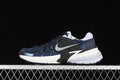 Side view of navy Nike V2K Run sneakers with black and white details