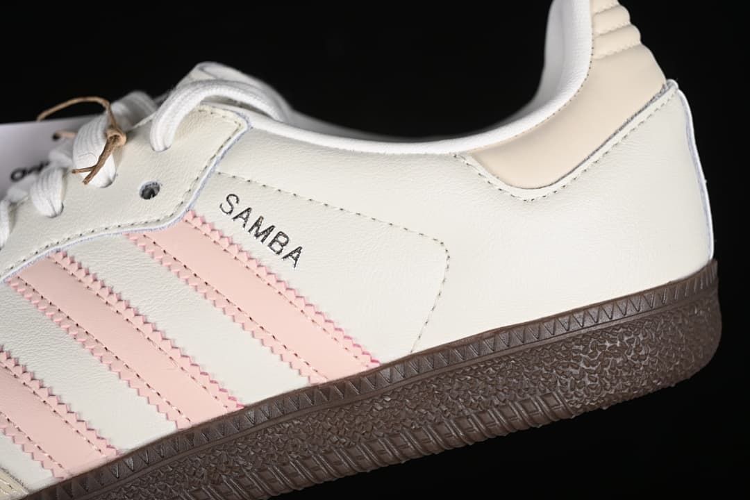 Close-up of the Samba side panel, pink stripes, and dark outsole