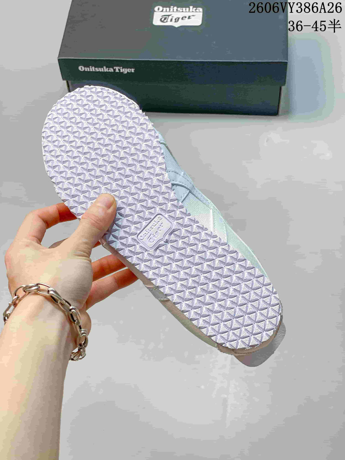 Close-up of the white sneaker outsole with a repeating geometric tread pattern