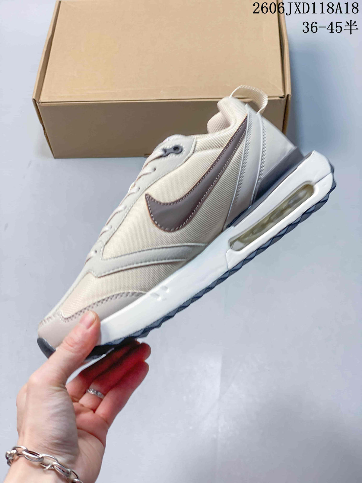 Side view of a light neutral Nike Air Max Dawn sneaker with a visible heel Air unit