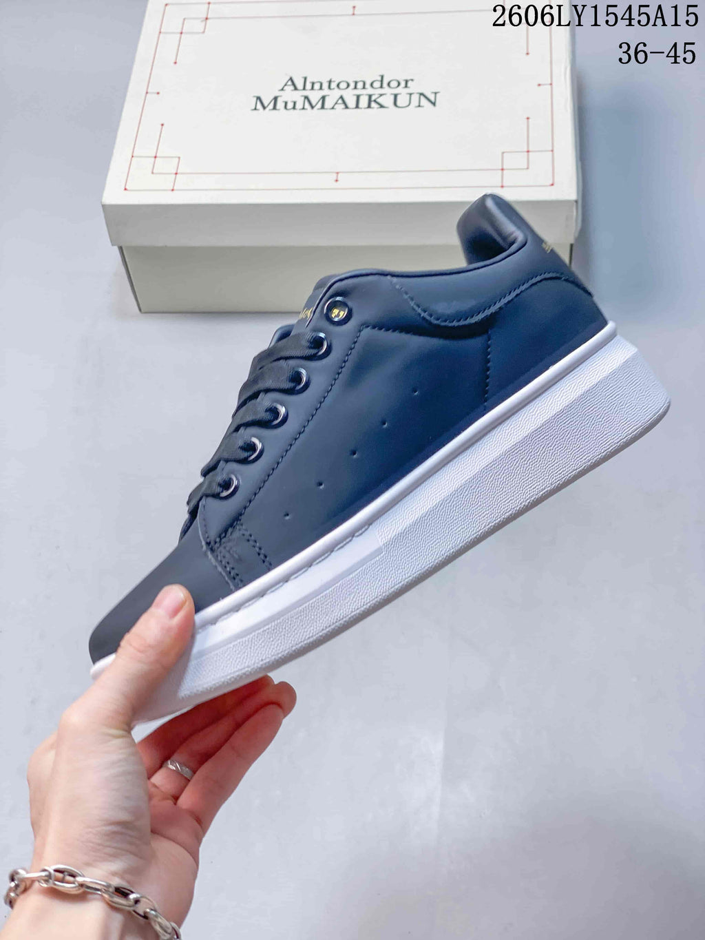 Side view of a navy low-top sneaker with perforated panels, laces, and a thick white sole.