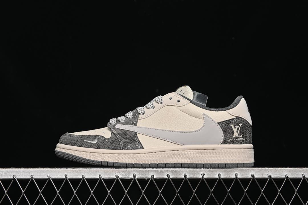 Side view of a cream and gray low-top sneaker with dark patterned overlays and a pale side panel.