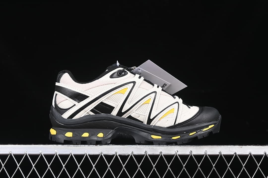 Side profile of one shoe showing its layered panels and yellow accents.