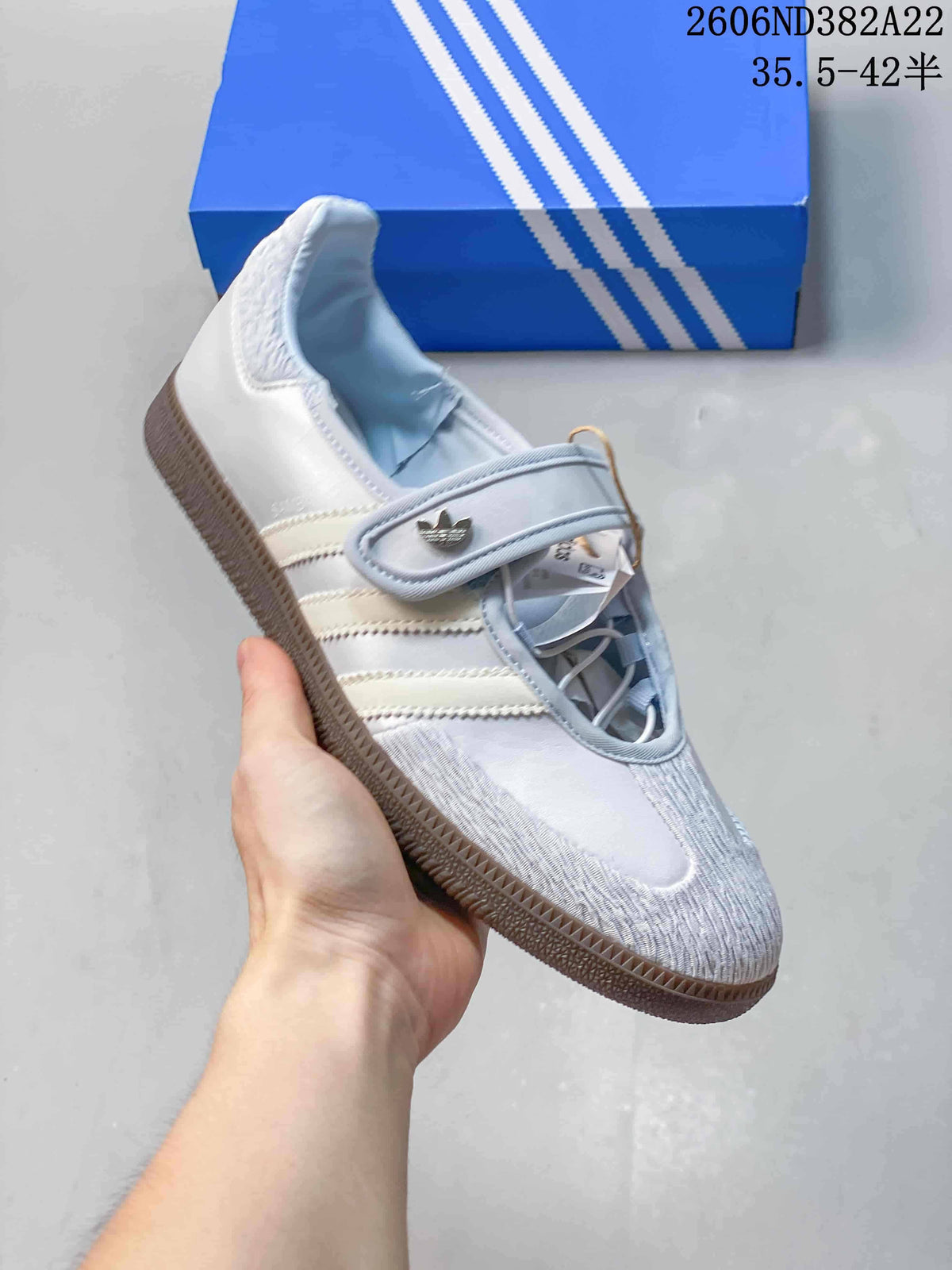 Angled view of a pale Adidas Samba Jane sneaker with a Mary Jane strap and textured toe.