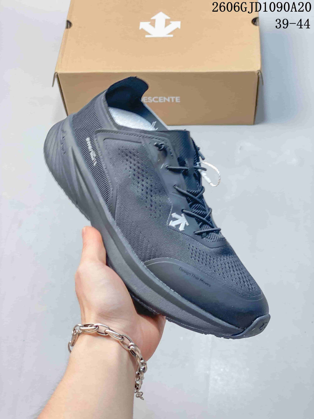 Angled side view of a dark gray Descente running shoe