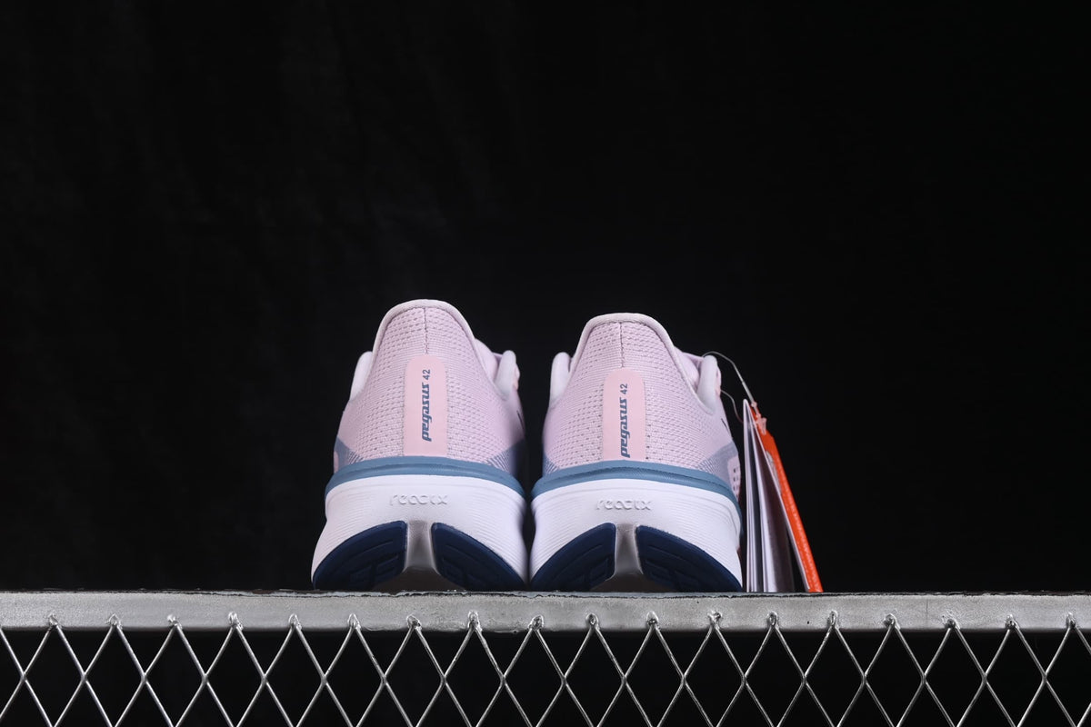 Rear view showing the pink heel panels, Pegasus 42 heel branding, and outsole details.