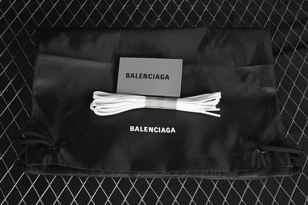 Black drawstring bag, card and spare white laces shown with Balenciaga branding