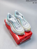 Pair of white Nike Air Max 97 sneakers with aqua and pale gold accents, shown on a red shoe box