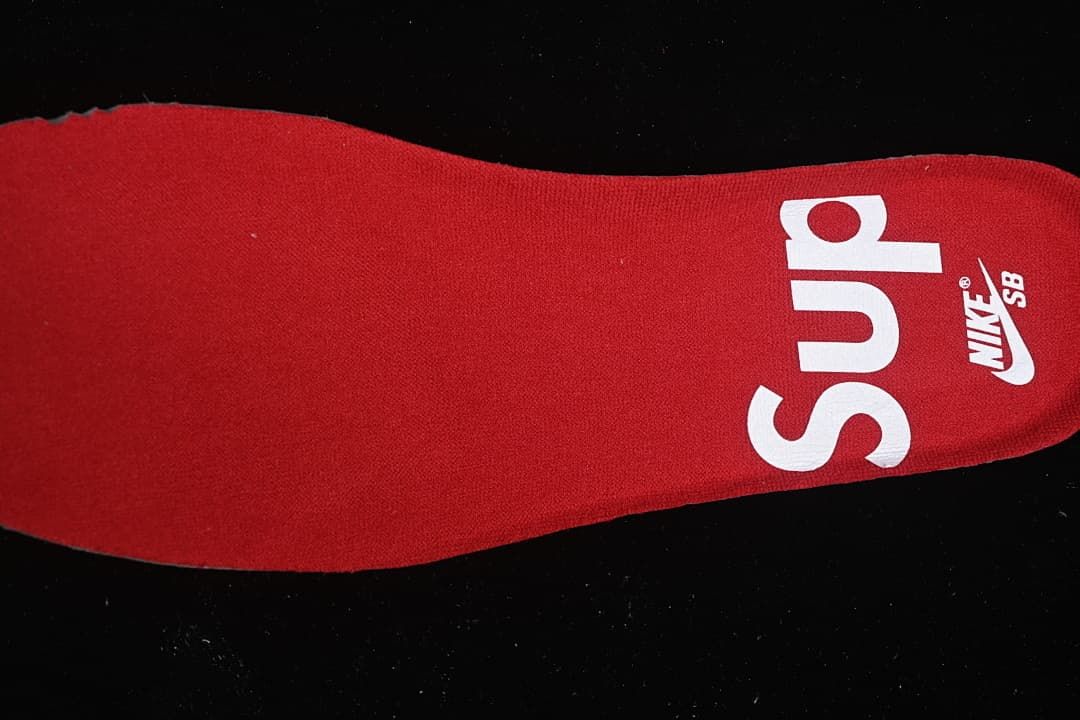 Red insole with Nike SB and Supreme branding