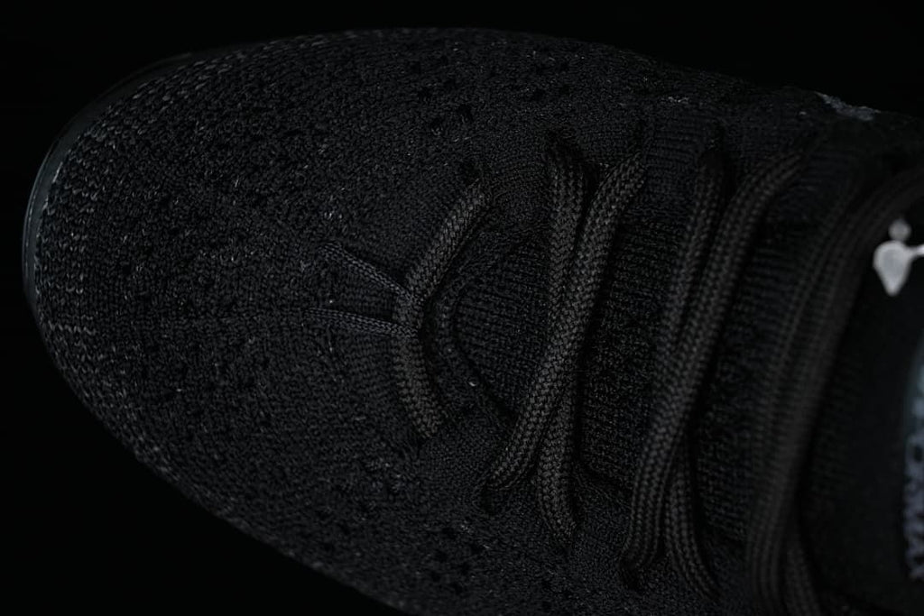 Top view of the black knit toe and lace-up upper