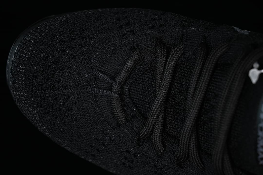 Top view of the black knit toe and lace-up upper