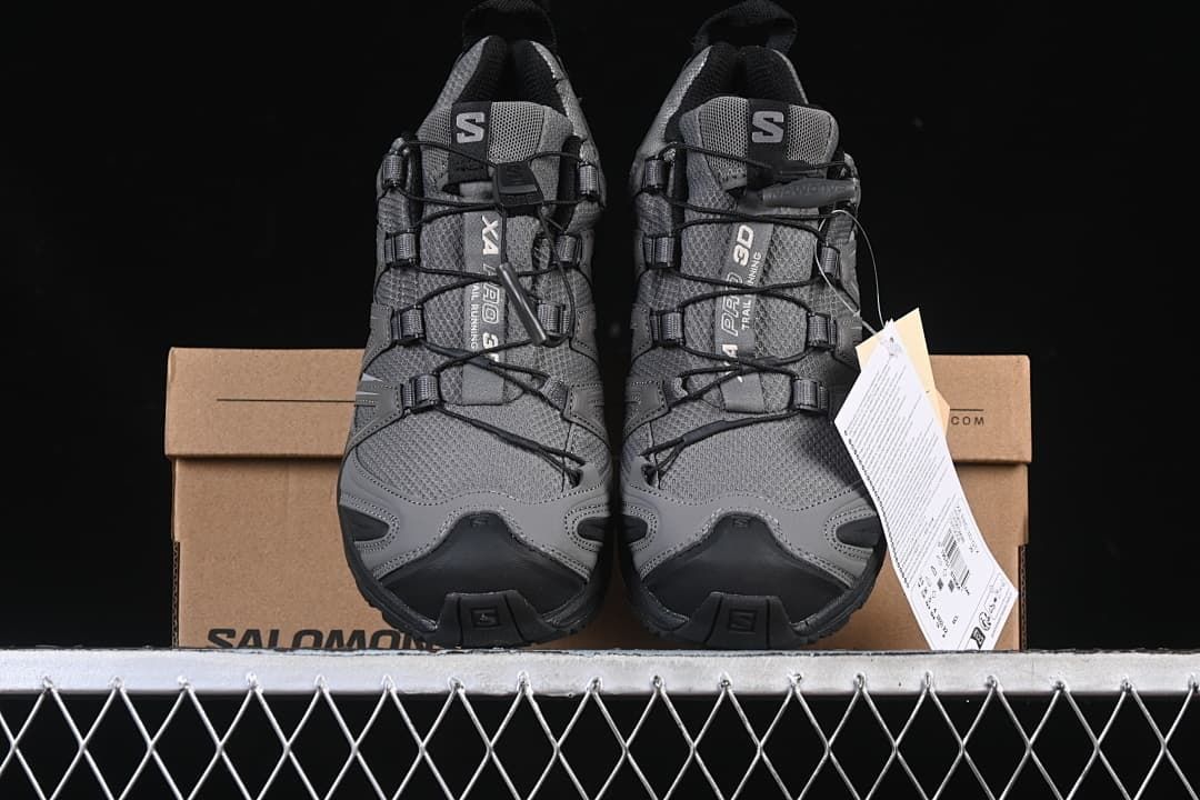 Pair of shoes displayed from the front on a Salomon shoe box.