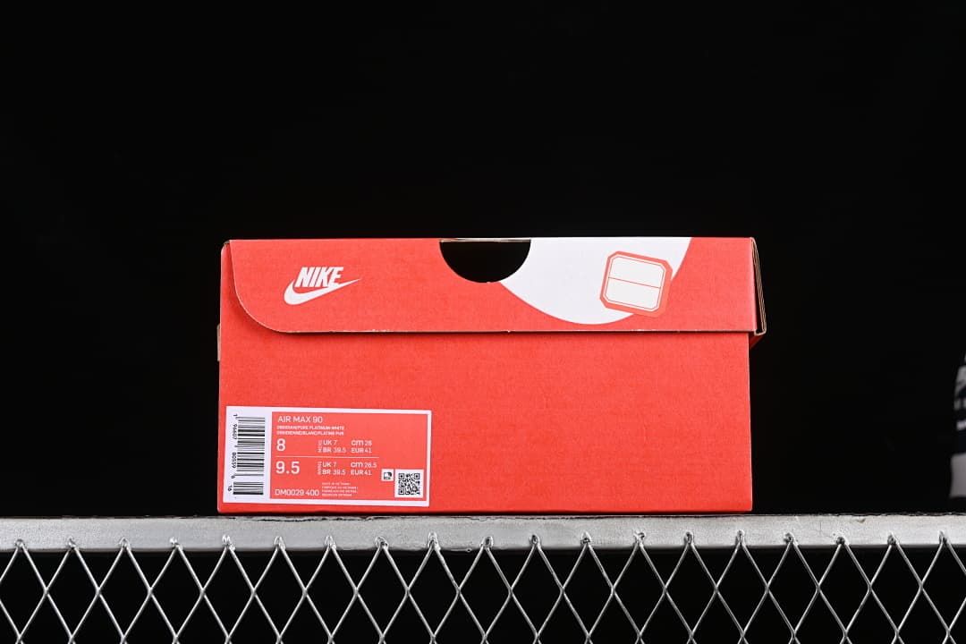 Red Nike shoe box with Air Max 90 label showing sample sizes