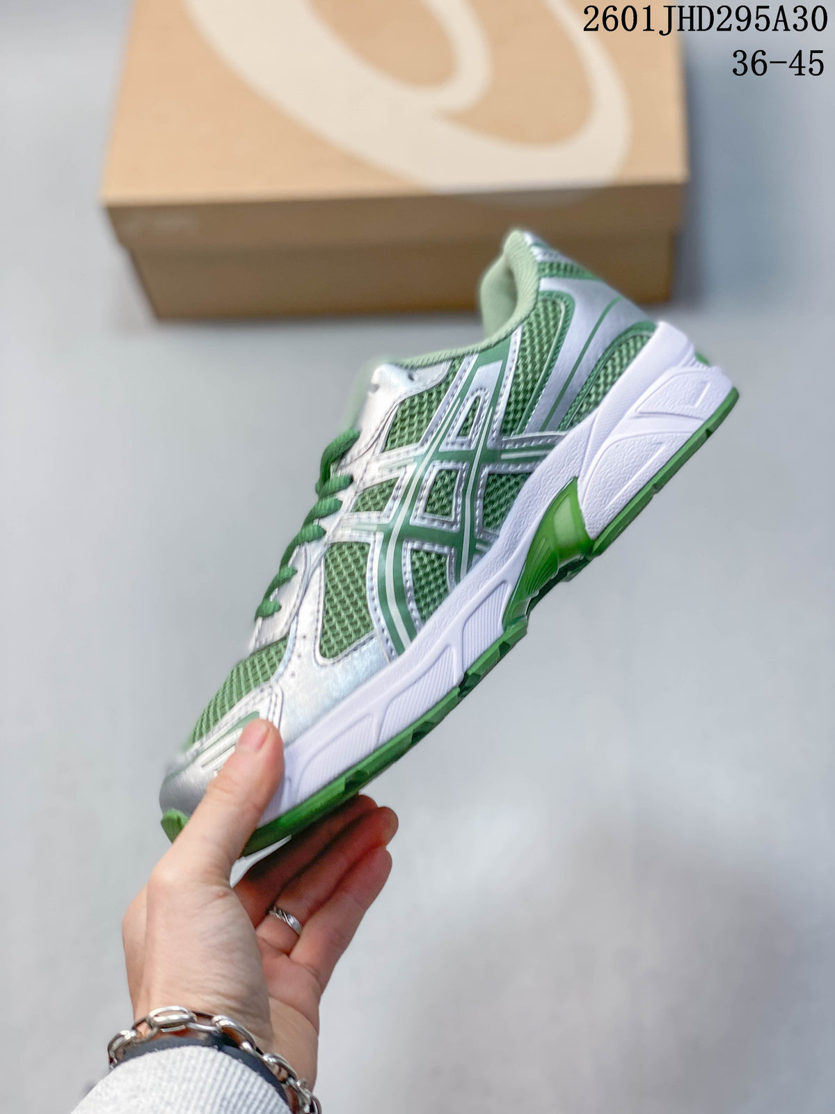 Side profile of the green and silver ASICS GEL-NIMBUS 10.1 sneaker.