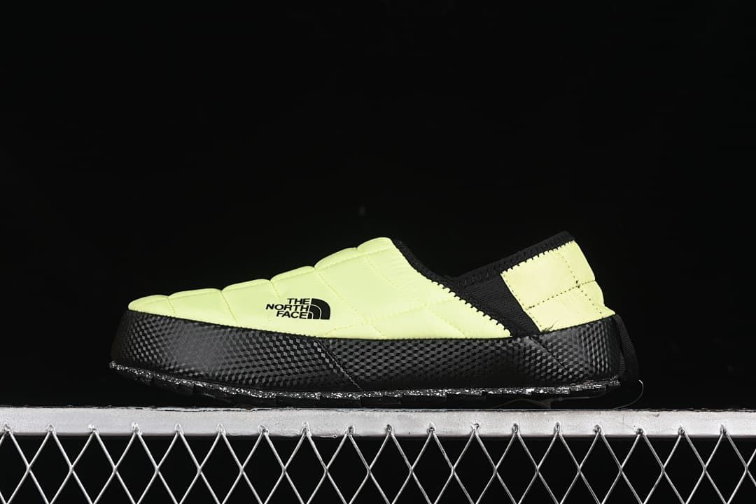 Side view of a bright yellow and black The North Face Thermoball Traction slip-on shoe.