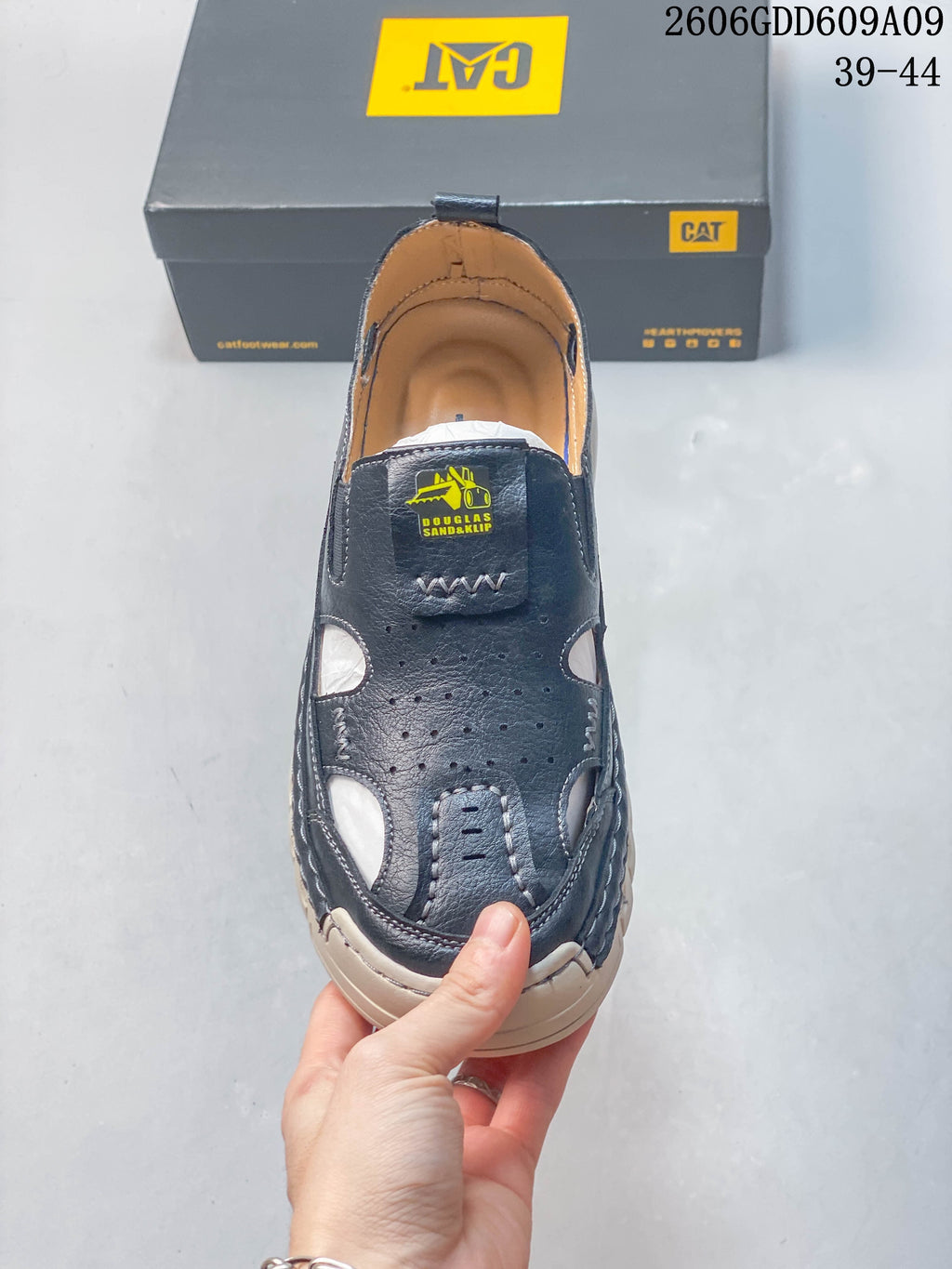 Top view of a navy closed-toe fisherman sandal with perforations, cutouts, and a logo patch; image overlay shows sizes 39–44.