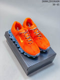 Pair of orange Nike Air Liquid Max shoes with gray laces and translucent blue soles, displayed on a box.