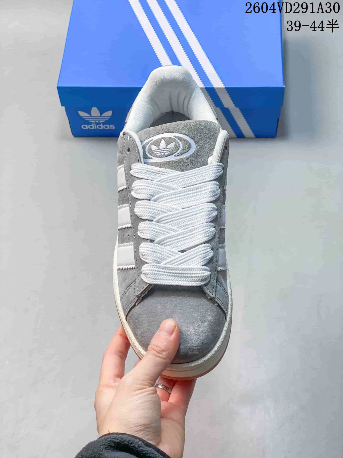 Front view of the grey sneakers with white laces