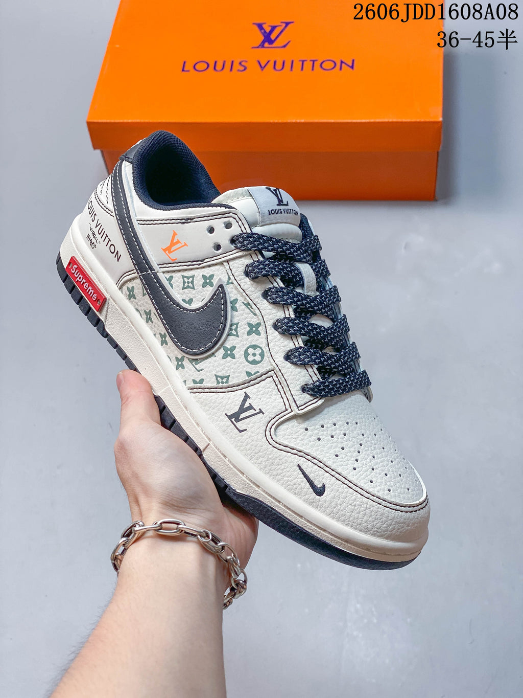 Angled side view of a cream and gray low-top sneaker with patterned panels and printed details