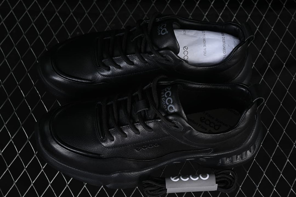 Pair of black lace-up sneakers displayed from above