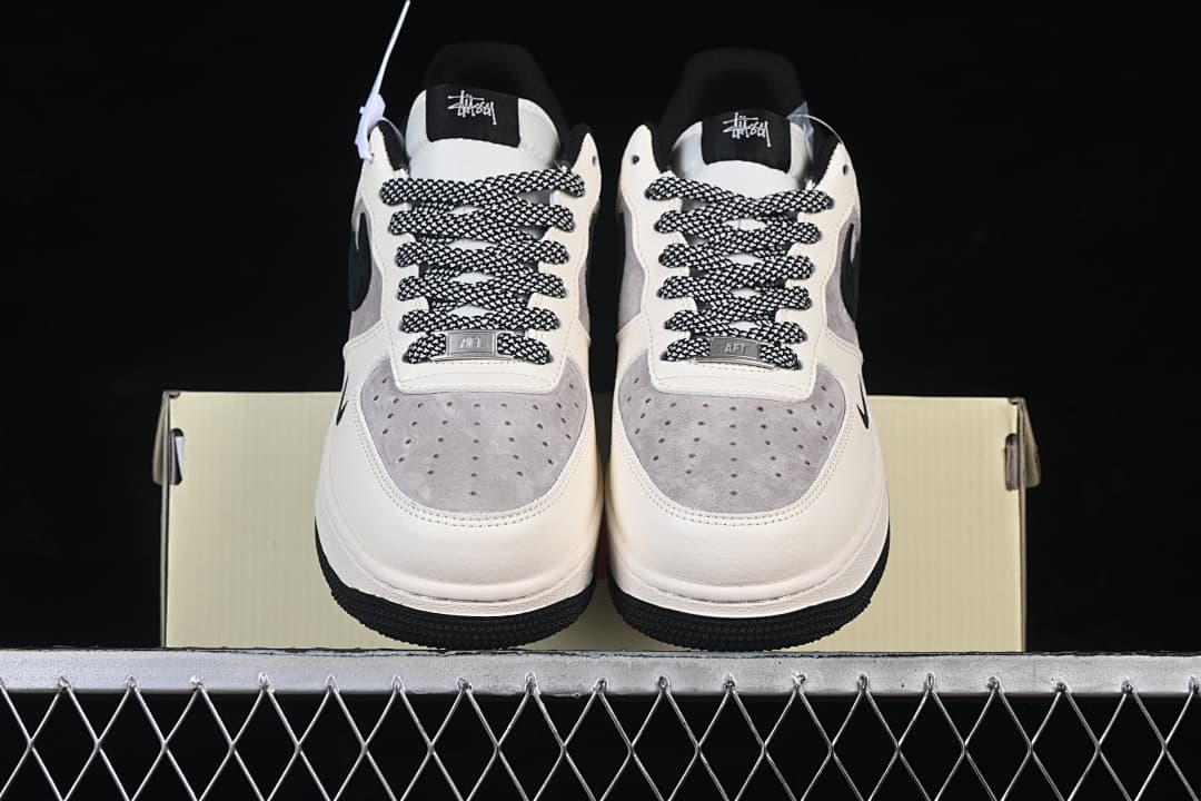 Front view of the pair showing grey perforated toe panels and patterned laces.