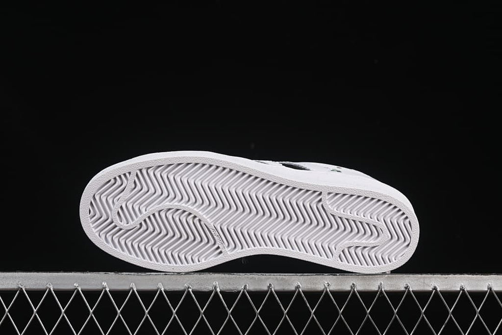 Underside of the sneaker showing a grooved outsole