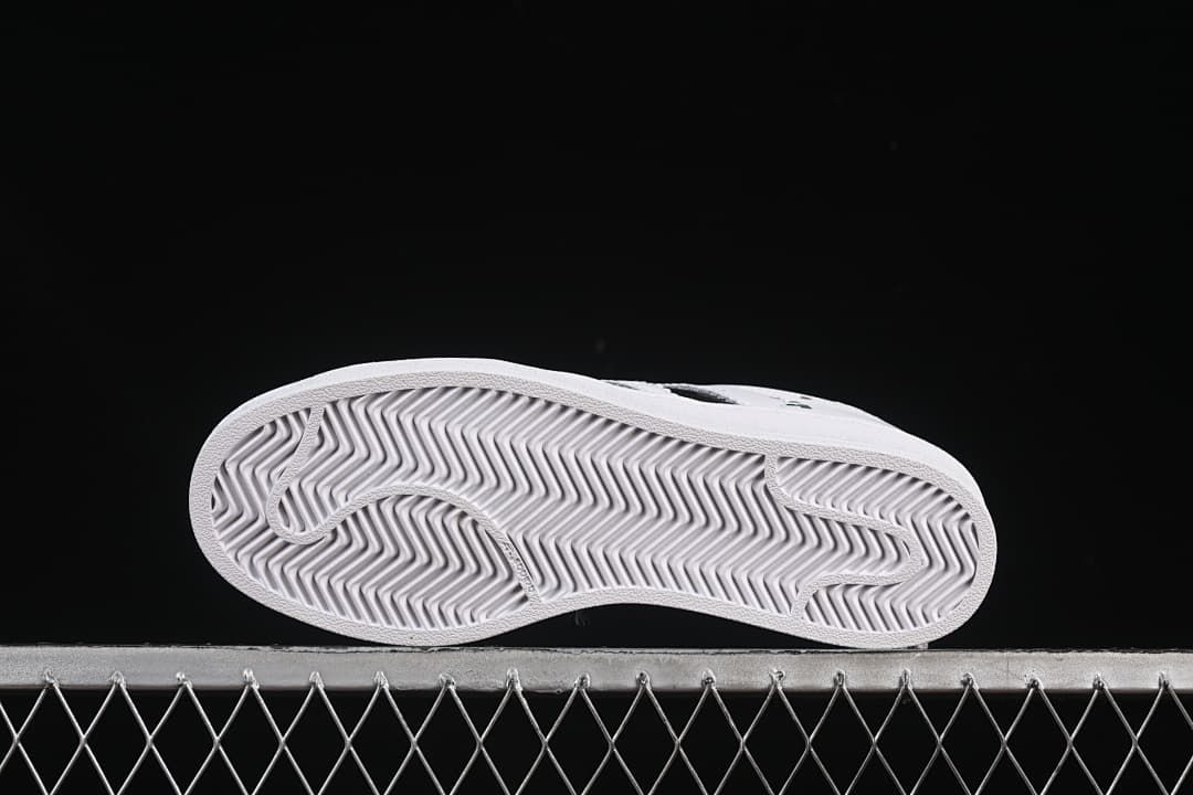 Underside of the sneaker showing a grooved outsole