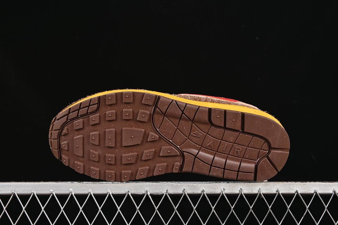 Brown outsole with segmented tread and yellow midsole edge.