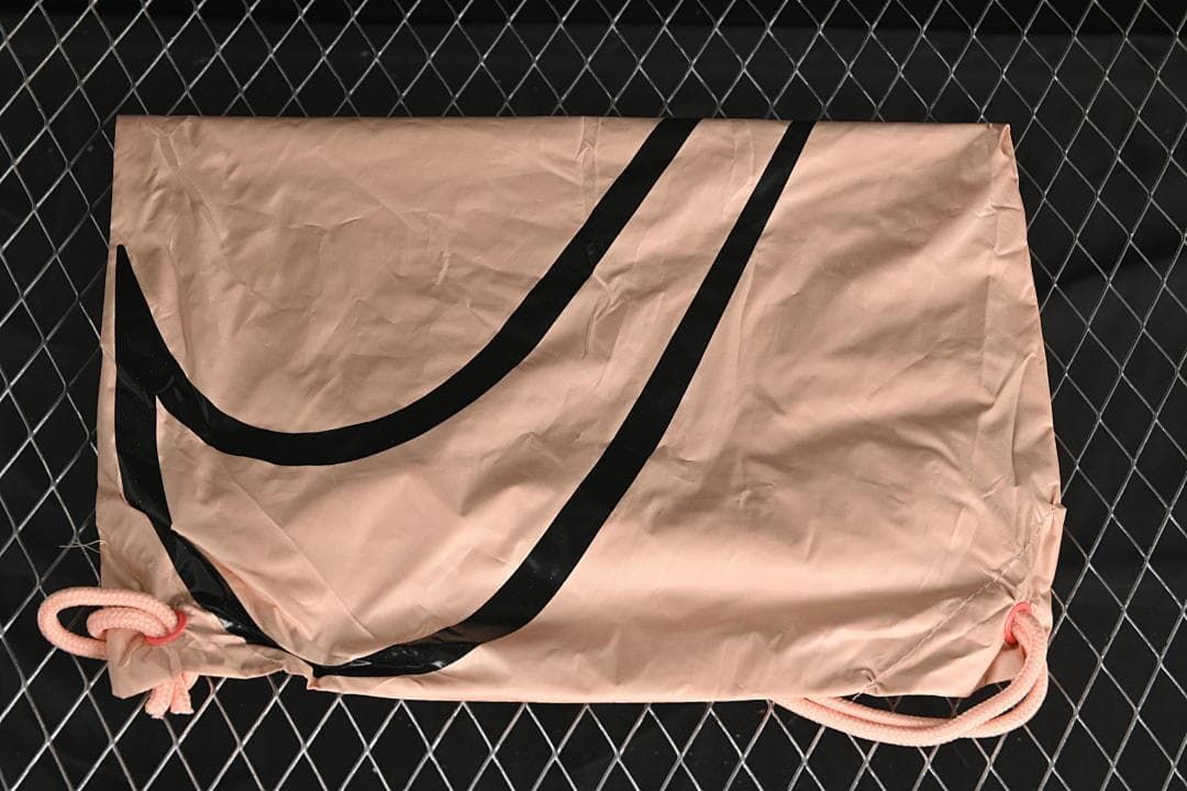 Nike-branded drawstring shoe bag shown against a dark background