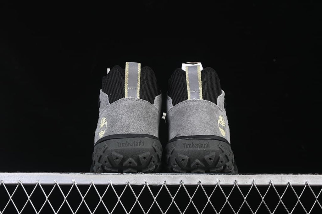 Rear view of both shoes showing heel panels, pull loops, and patterned outsoles.