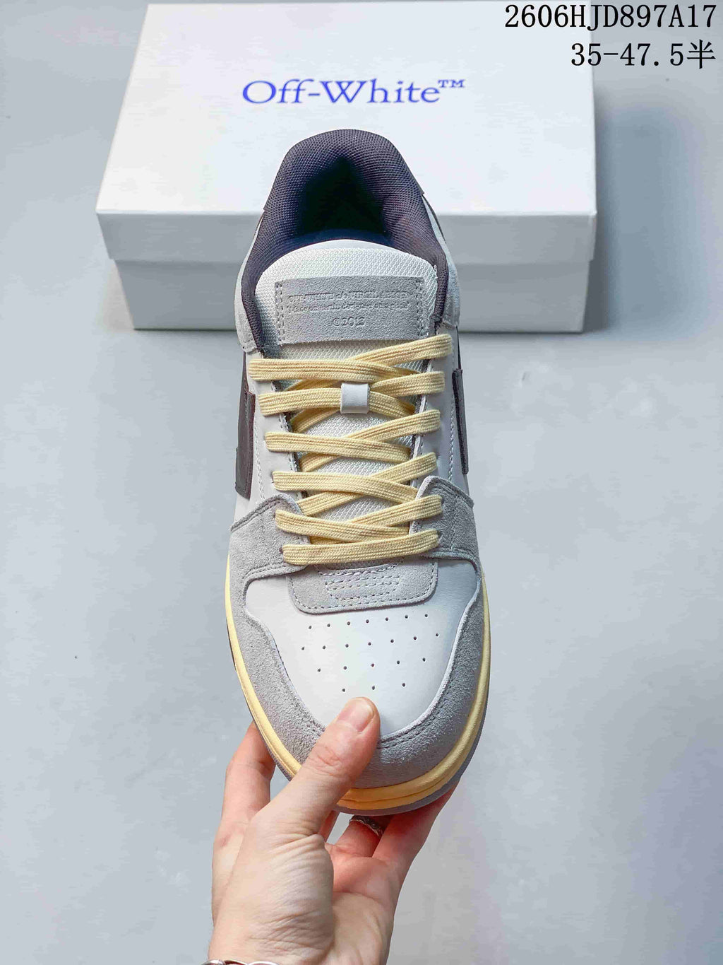 Top view showing the sneaker's laces, perforated toe panel, and grey overlays
