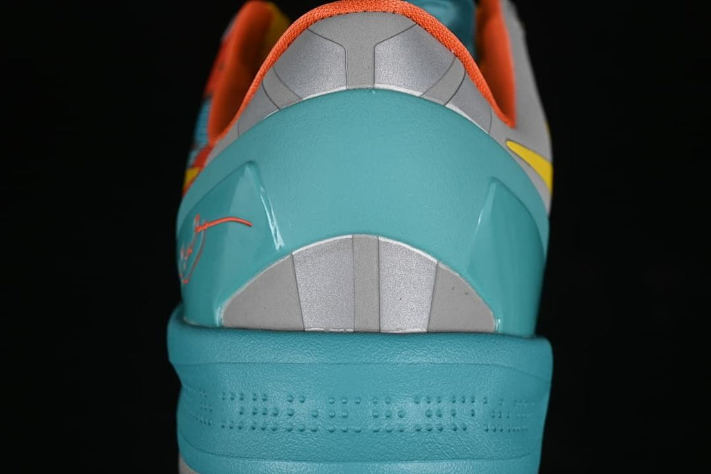 Rear view highlighting the turquoise heel counter and gray details