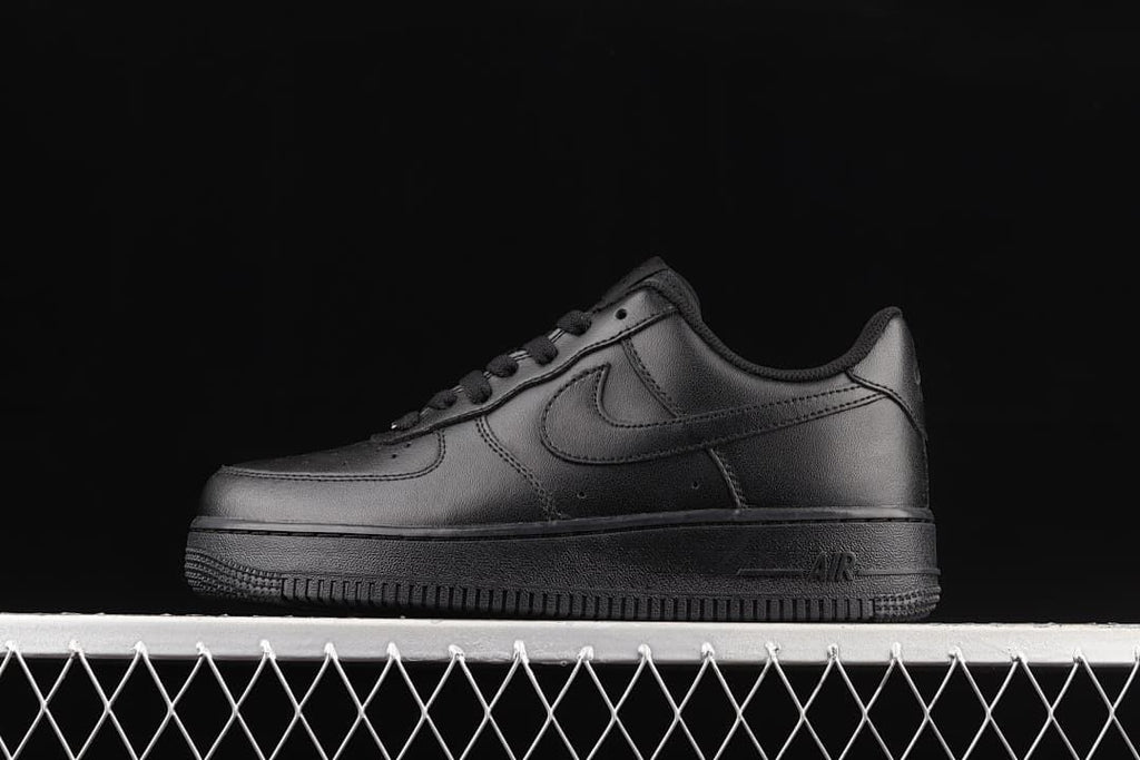 Side view of an all-black Nike Air Force 1 '07 Low sneaker.