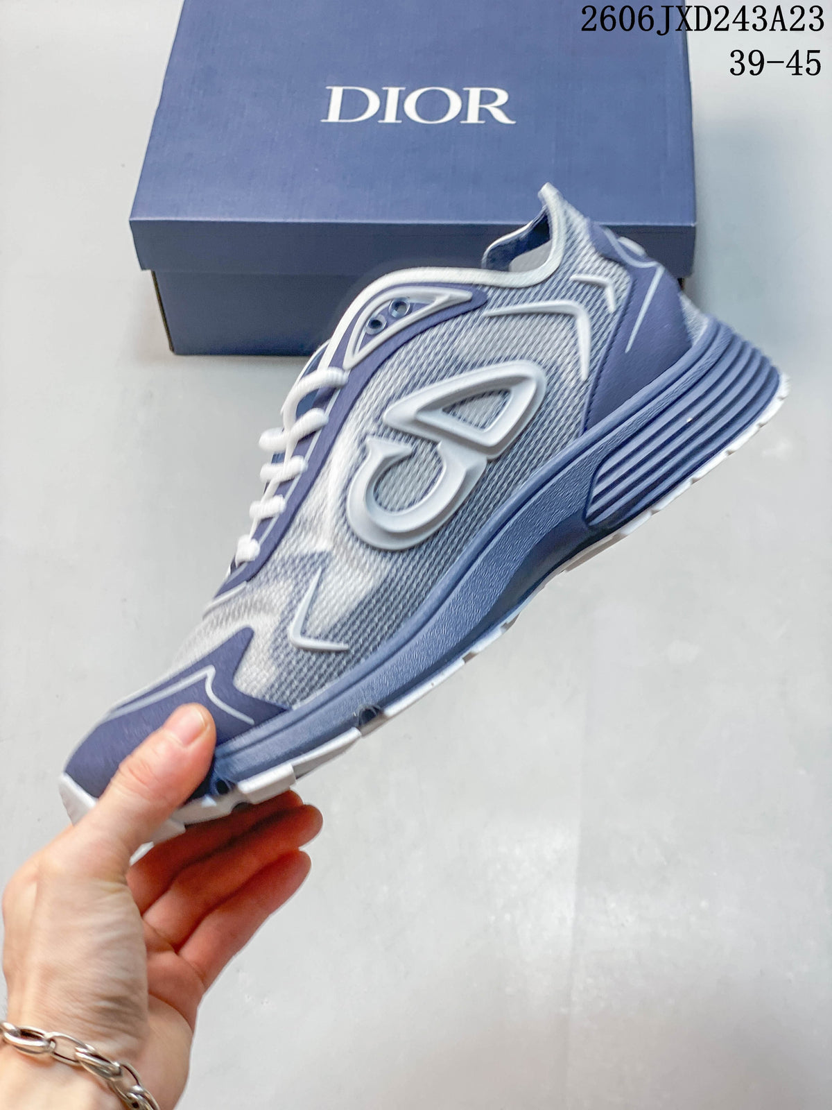 Side view of the sneaker showing its mesh-style upper and raised side details