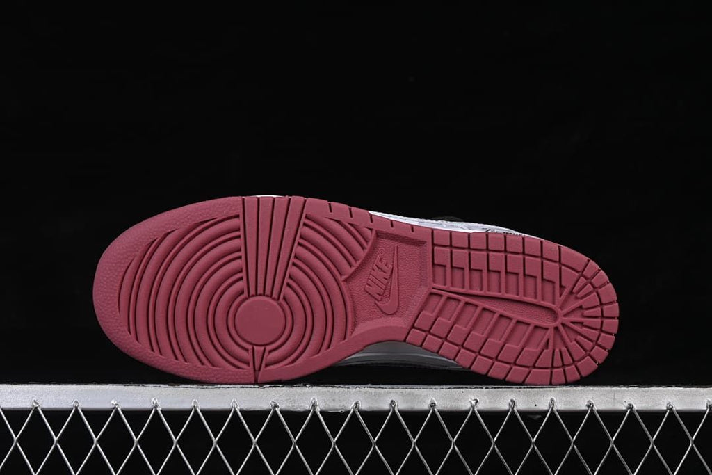 Burgundy outsole with circular forefoot traction and segmented tread