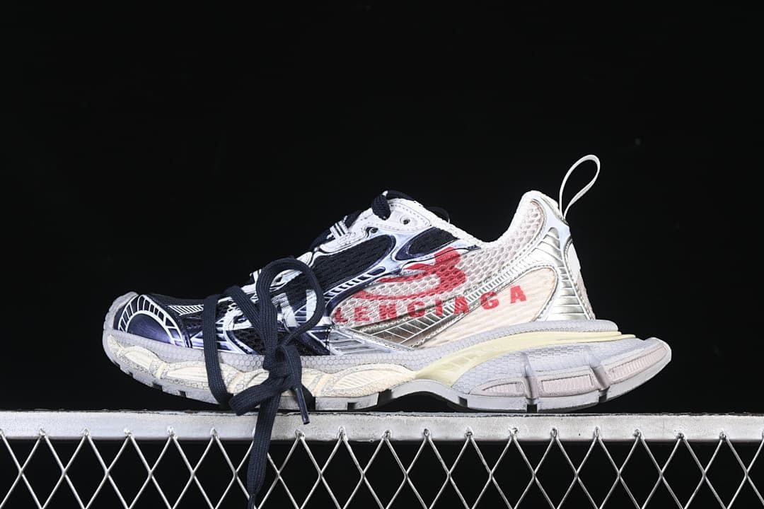 Side view of Balenciaga 3XL sneakers in eggshell, navy, black, and red.