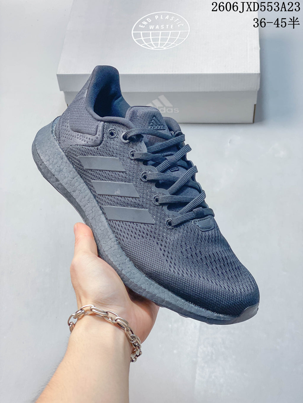 Angled side view of a charcoal Adidas PureBoost 21 running shoe.