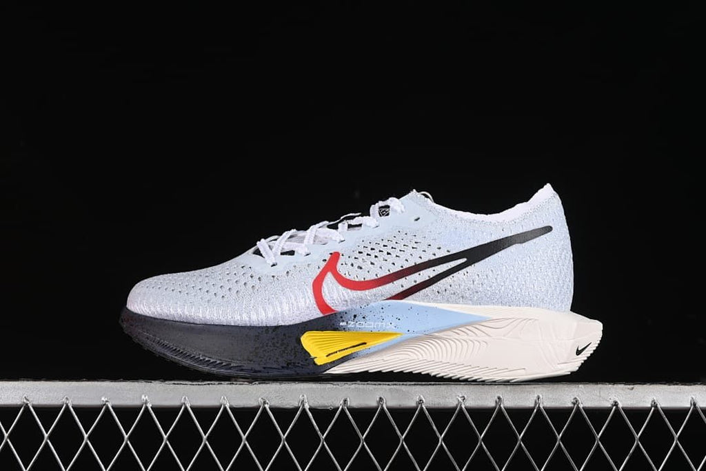 Side view of white Nike ZoomX Vaporfly NEXT% 3 running shoe with red and black Swoosh details
