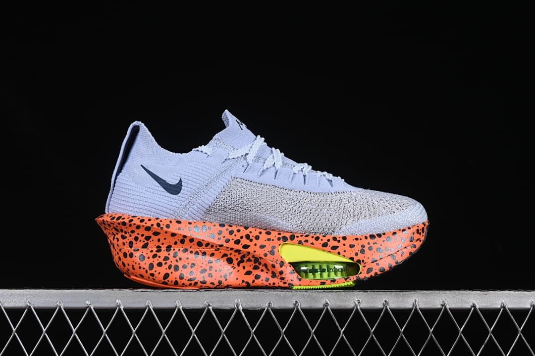 Side profile showing the pale lavender upper, dark Swoosh, and orange speckled sole.