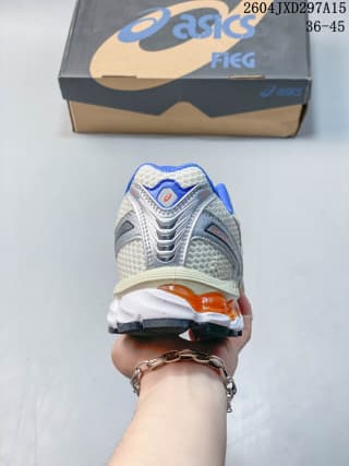 Rear view of the sneaker showing the heel structure, blue detail, orange accent, and black outsole sections.