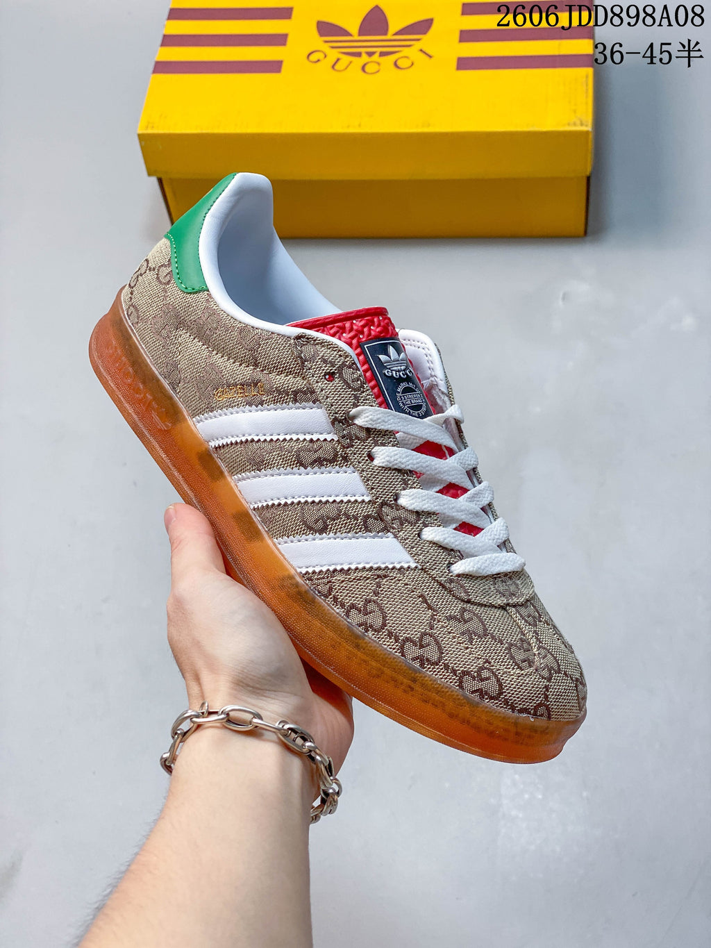 Side view of a beige patterned sneaker with white stripes and an amber-toned outsole